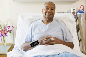 patient wearing continuous blood pressure device