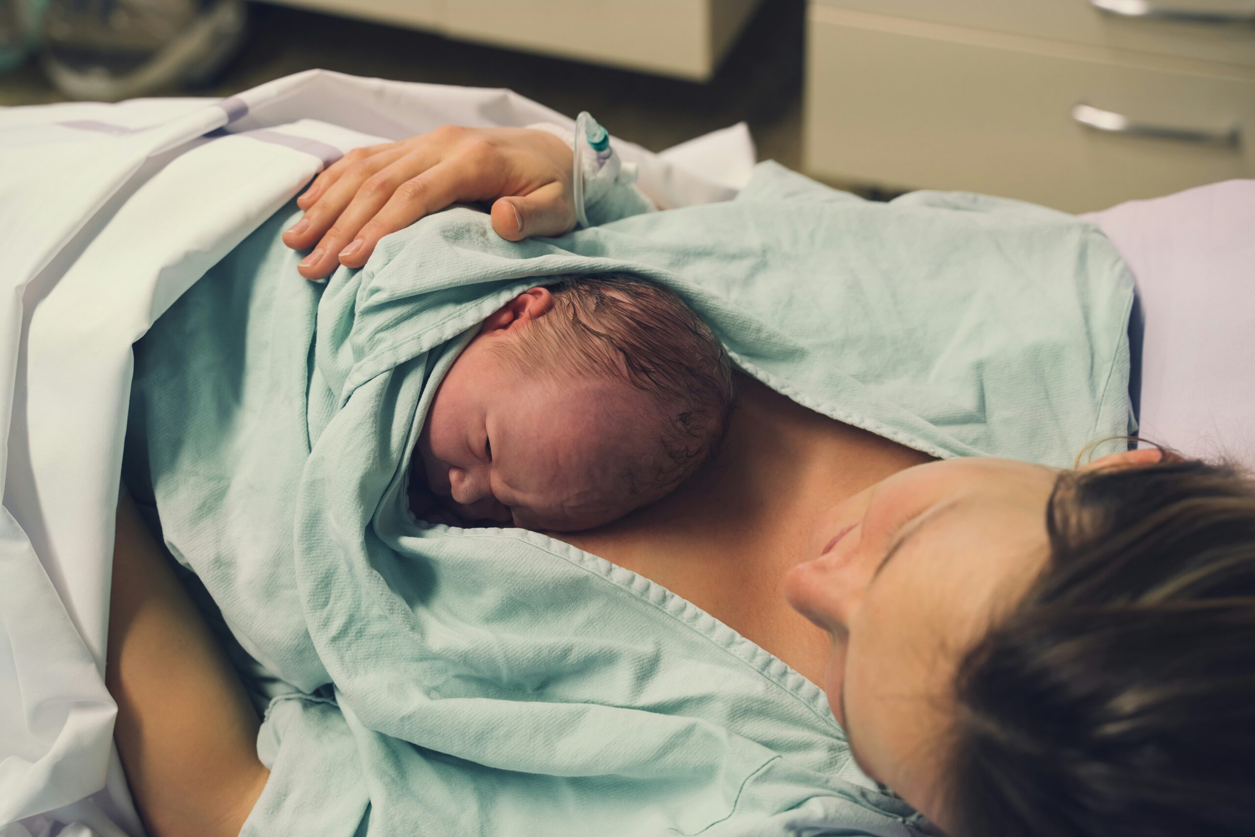 New mother holding her baby in the hospital